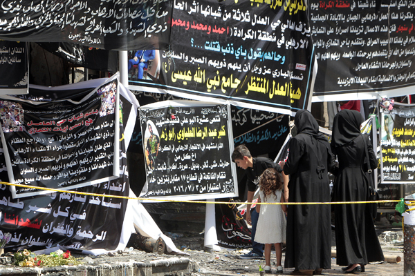 Iraqis Gather On Thursday Next To Banners Of Condolences At A Memorial 