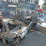 People Inspect The Site Of A Suicide Car Bombing In The Karrada