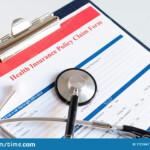 Blank Health Insurance Policy Claim Form With Stethoscope On Clipboard